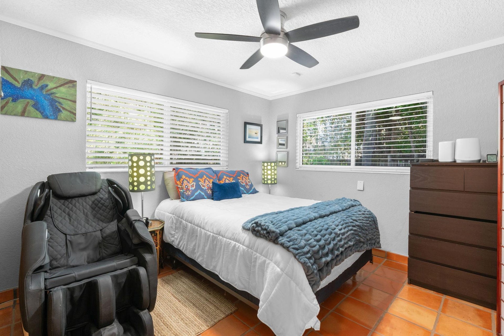 2956 NW 6th Terrace, Wilton Manors, FL 33311 Comfortable bedroom featuring tile flooring, ceiling fan, and generous window placement. Layout accommodates a full bed and additional furnishings.