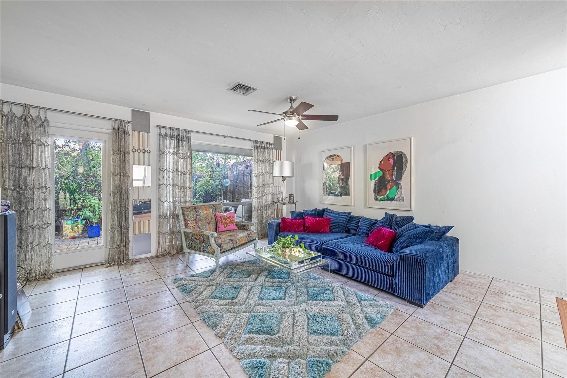 Unit 1013 living room with entry/exit door to the private, fenced patio.