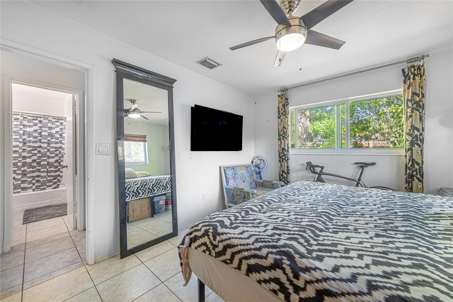 Unit 1013 first bedroom shows proximity to bathroom across the hall.