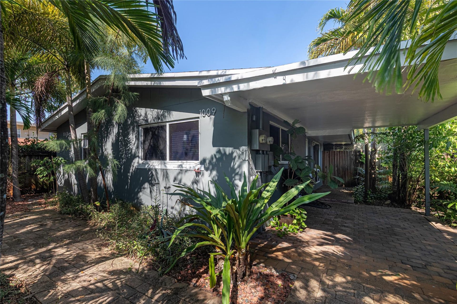 Front of duplex as you enter unit 1009 through the gate. This unit offers a large yard and covered portico for your outdoor enjoyment.