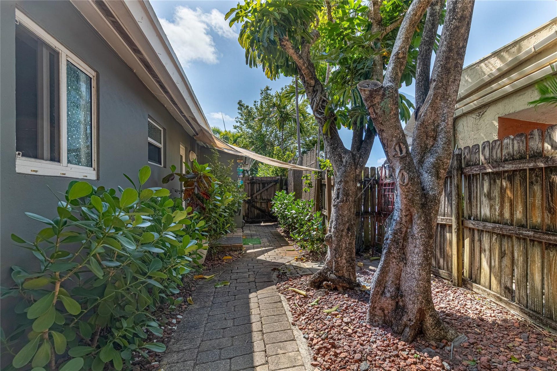 Unit 1013 wrap around view from back to front door entry. Unit is fully fenced and gated.