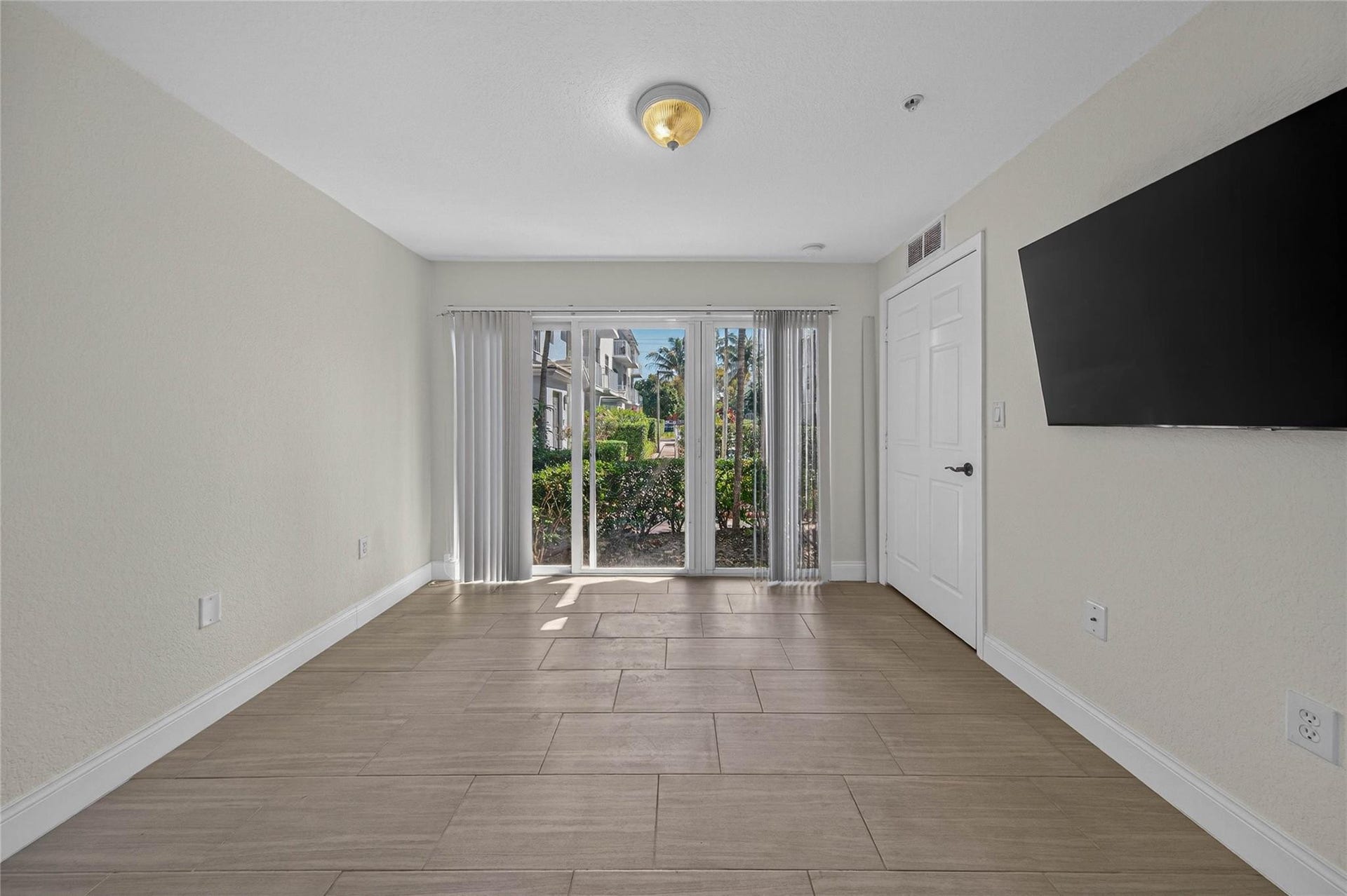 First floor bedroom with wall of sliders