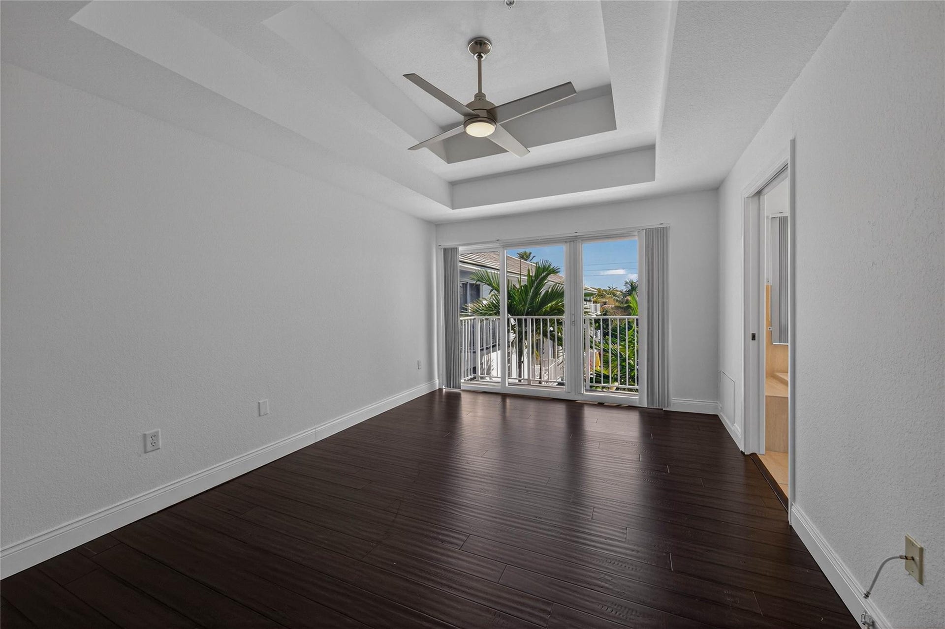 Primary bedroom with double tray ceilings.