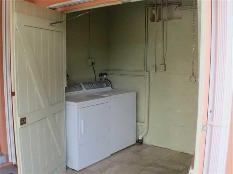 Exterior Front. Large Laundry and storage room off the carport, just outside the kitchen/carport door.