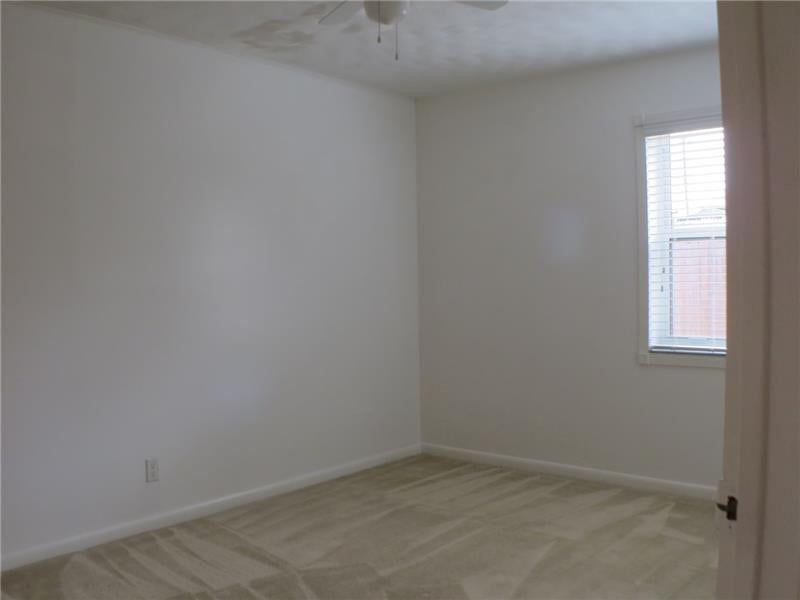 Exterior Front. Guest Bedroom Detail 1, carpeted in neutral tones.