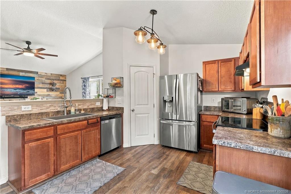2134 SE Gaslight Street, Port St Lucie, FL 34952 Kitchen with wood cabinetry and stainless appliances