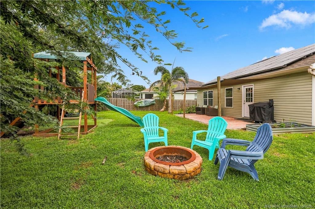 2134 SE Gaslight Street, Port St Lucie, FL 34952 Backyard featuring fire pit