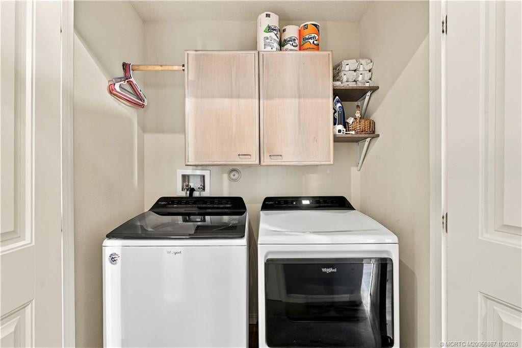 2134 SE Gaslight Street, Port St Lucie, FL 34952 Laundry area with washer and dryer hookups