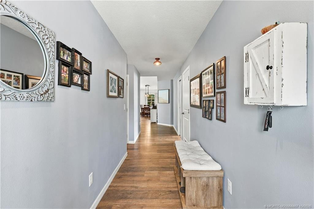 2134 SE Gaslight Street, Port St Lucie, FL 34952 Foyer entry with wood-look flooring leading into main living space