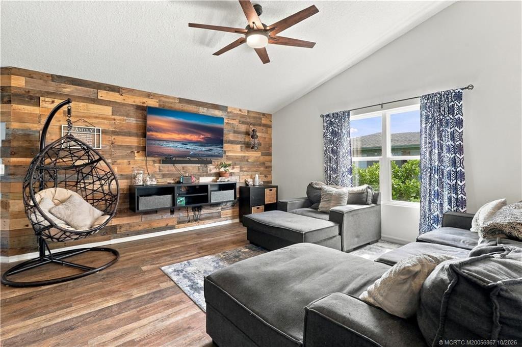 2134 SE Gaslight Street, Port St Lucie, FL 34952 Living room featuring wood accent wall