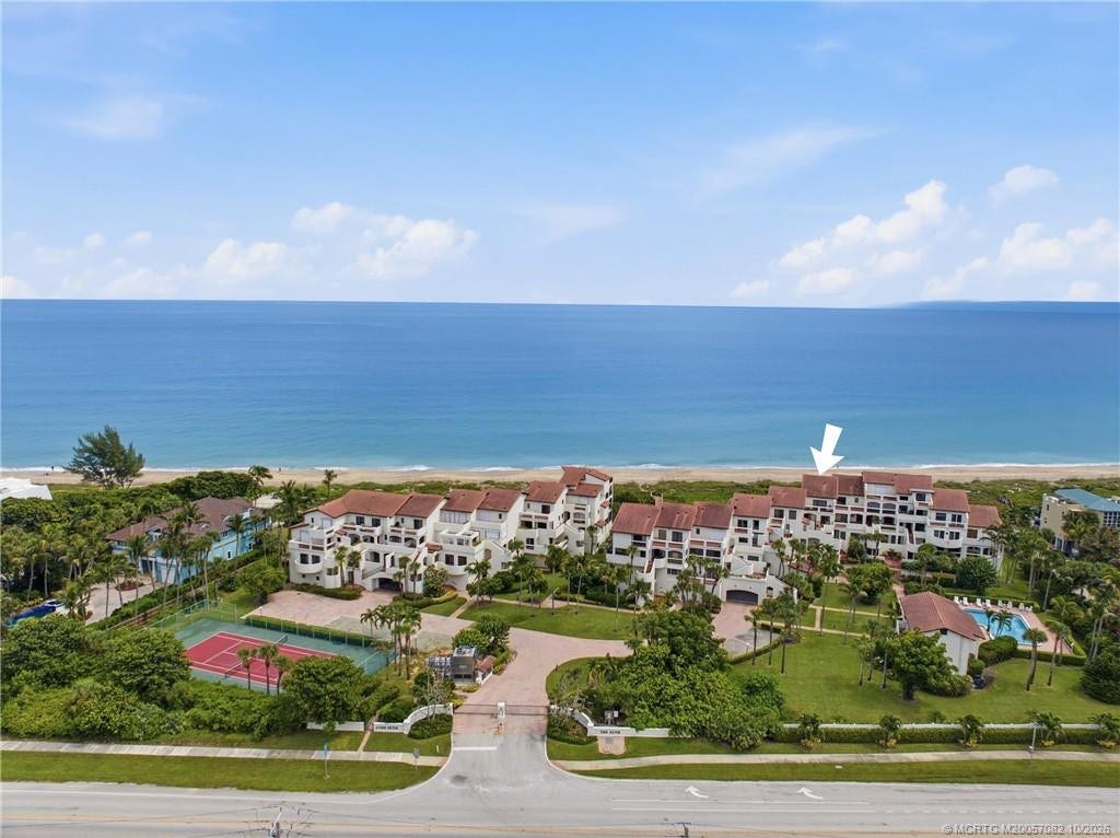 Aerial perspective showcasing The Dune's intimate oceanfront setting with community tennis and pool amenities.