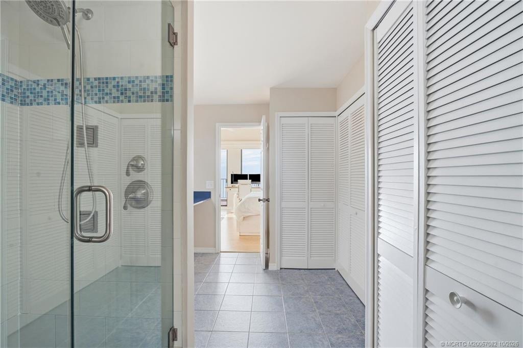 Spacious primary bath offers generous closet storage and a large walk-in shower, with direct access to the primary suite.