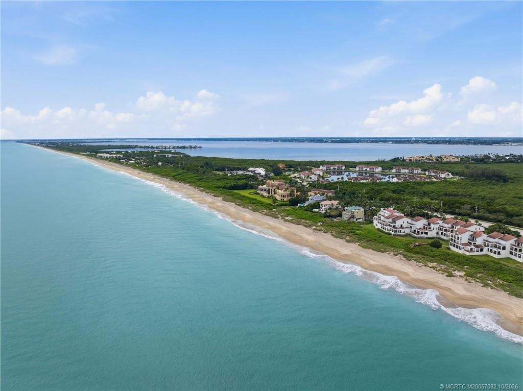 Expansive aerial perspective showcases miles of coastline with the Atlantic Ocean and Indian River framing Hutchinson Island.