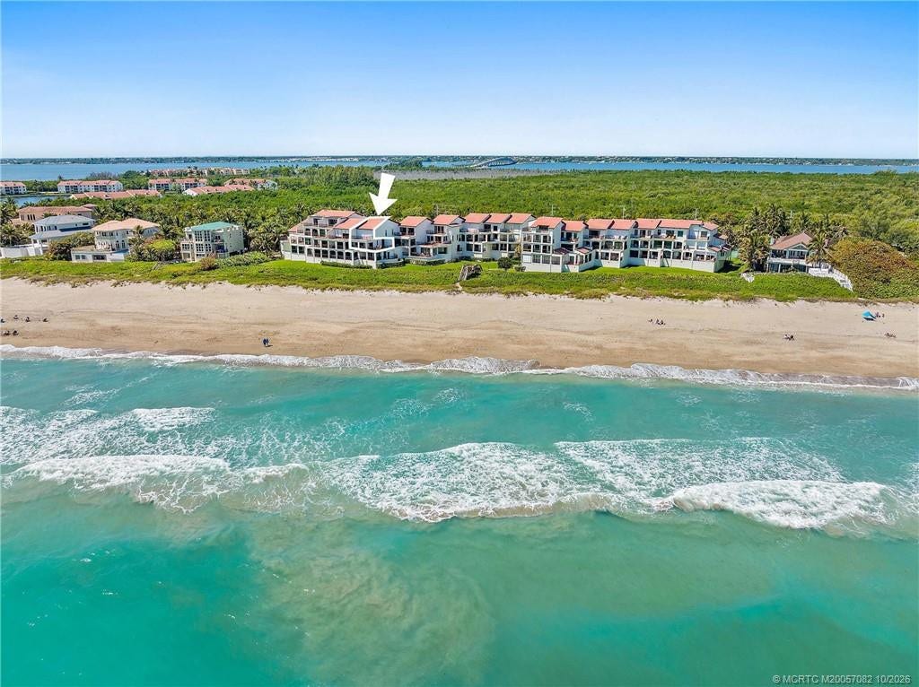 Aerial view identifies the residence and highlights its direct oceanfront location.