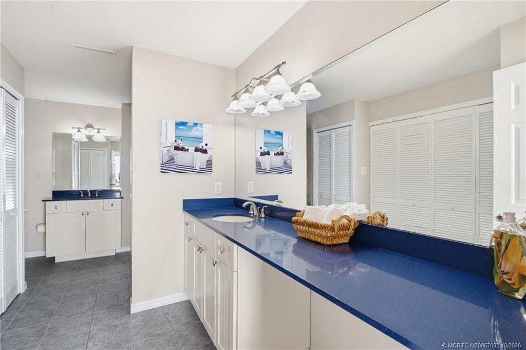 Spacious primary bath featuring dual vanities with generous counter space and a walk-in shower.