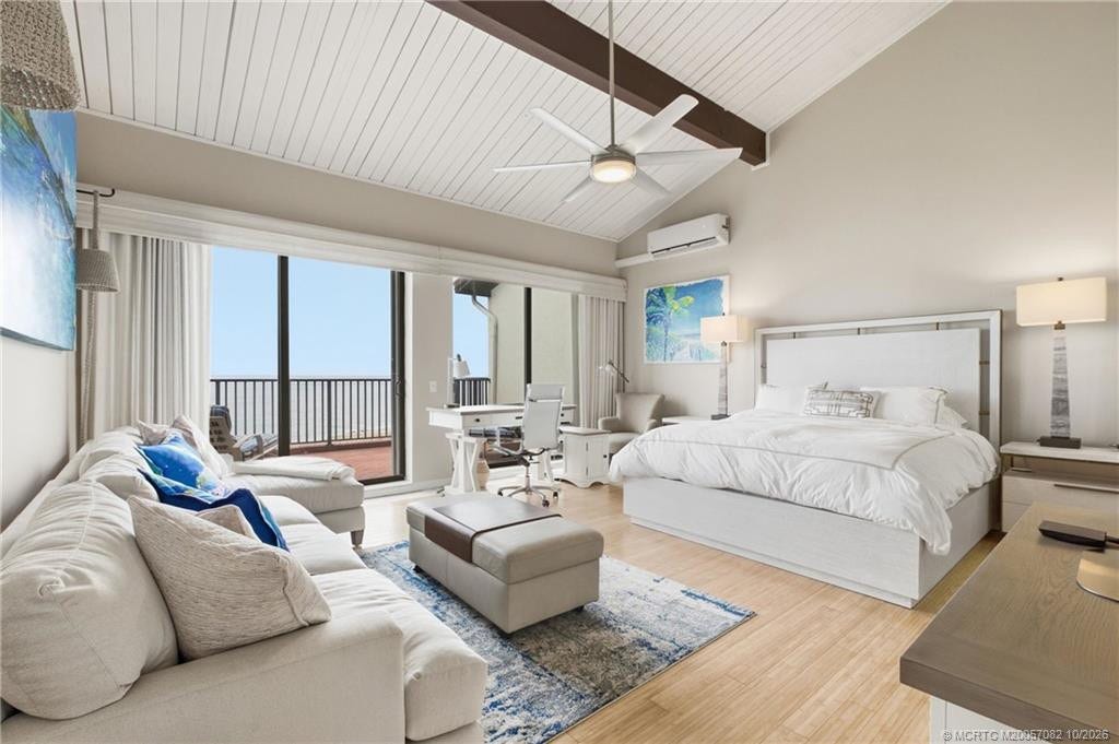 Expansive oceanfront primary suite with soaring vaulted ceilings, exposed beams, sitting area and direct balcony access.