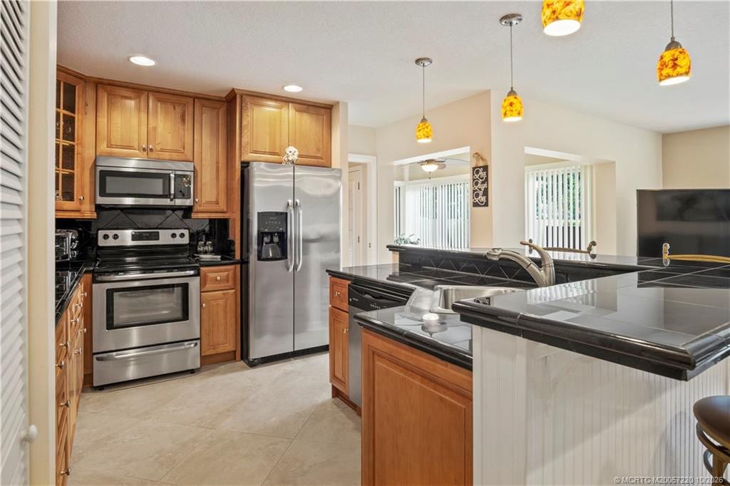1800 SE Saint Lucie Boulevard, #9-105, Stuart, FL 34996 One of a kind kitchen island with sink and dishwasher attached allowing for easy entertaining.