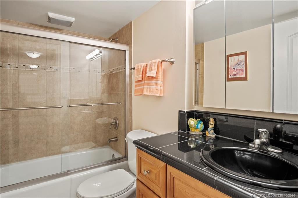 1800 SE Saint Lucie Boulevard, #9-105, Stuart, FL 34996 Tub shower in guest bathroom with granite countertops