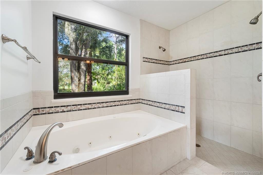 5820 SW Grove Street, Palm City, FL 34990 Jetted tub and walk in shower with shower heads on both walls.