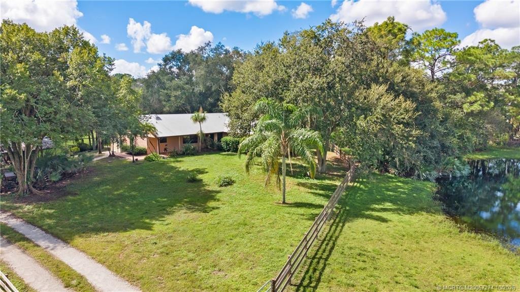5820 SW Grove Street, Palm City, FL 34990 Home surrounded by beautiful mature trees.