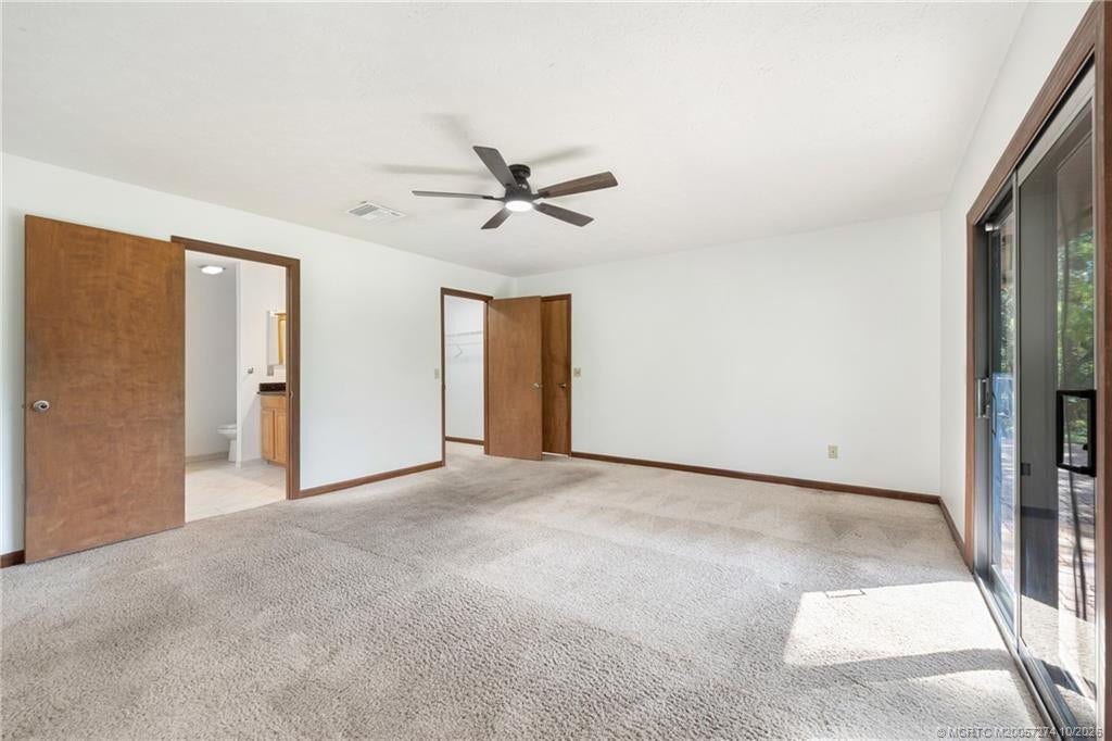 5820 SW Grove Street, Palm City, FL 34990 main bedroom with sliders to back patio and swim spa.