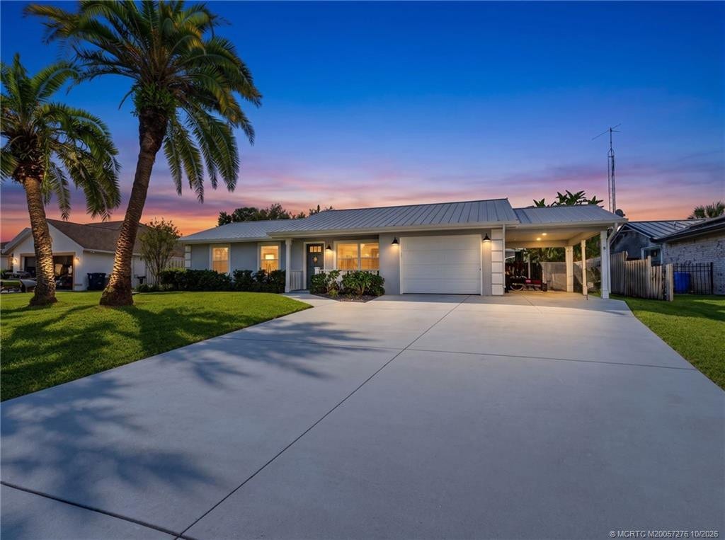 2657 SW Harem Circle, Port St Lucie, FL 34953 Home Sweet Home. Charming coastal style, a metal roof, and convenient garage and carport parking.