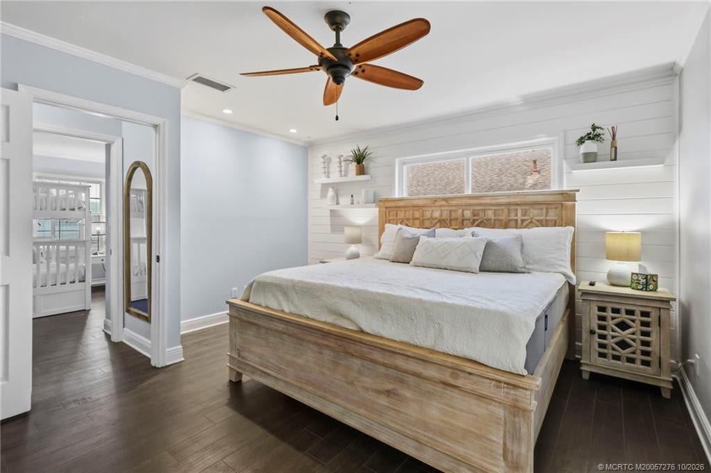 2657 SW Harem Circle, Port St Lucie, FL 34953 Relax in the spacious primary suite featuring wood-look flooring, soft neutral tones, and a calming coastal atmosphere.