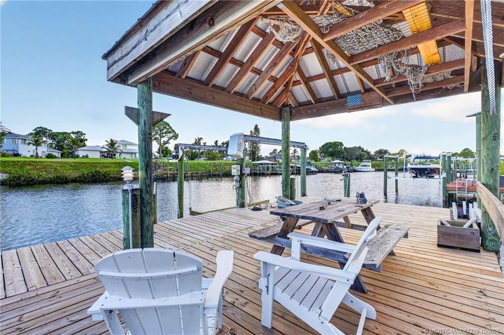 2657 SW Harem Circle, Port St Lucie, FL 34953 Unwind waterside beneath the shaded tiki-style gathering area, perfect for enjoying peaceful canal views.