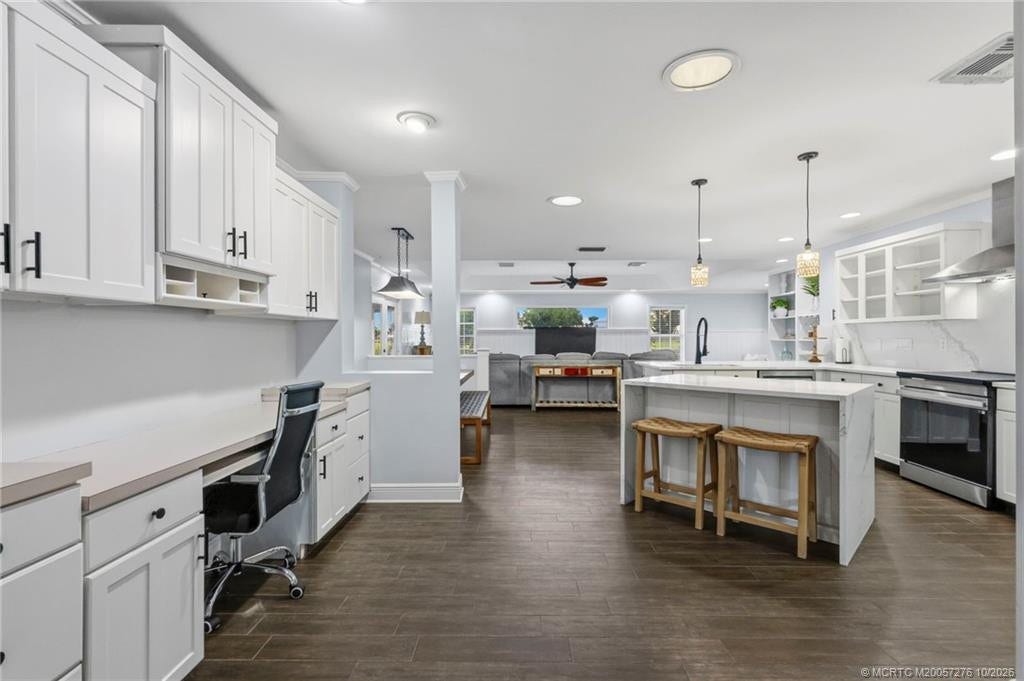 2657 SW Harem Circle, Port St Lucie, FL 34953 Spacious, open-concept living with attractive wood-look flooring, coastal-inspired finishes, and seamless flow between gathering spaces.