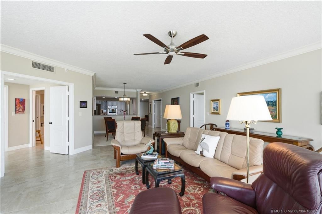 Generously sized living area with neutral tile flooring and an open layout ideal for entertaining.