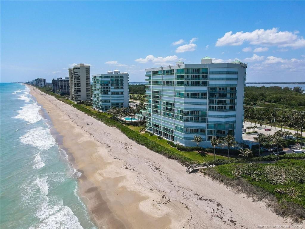 Beautiful perspective of Regency Island Dunes showcasing its direct oceanfront location, expansive sandy beaches, and private beach access.