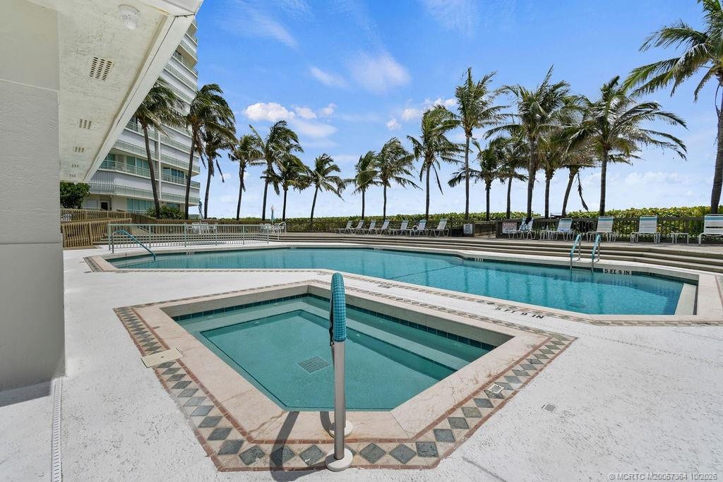 Relax and unwind at the resort-style swimming pool and hot tub, surrounded by spacious sun decks and tropical landscaping.
