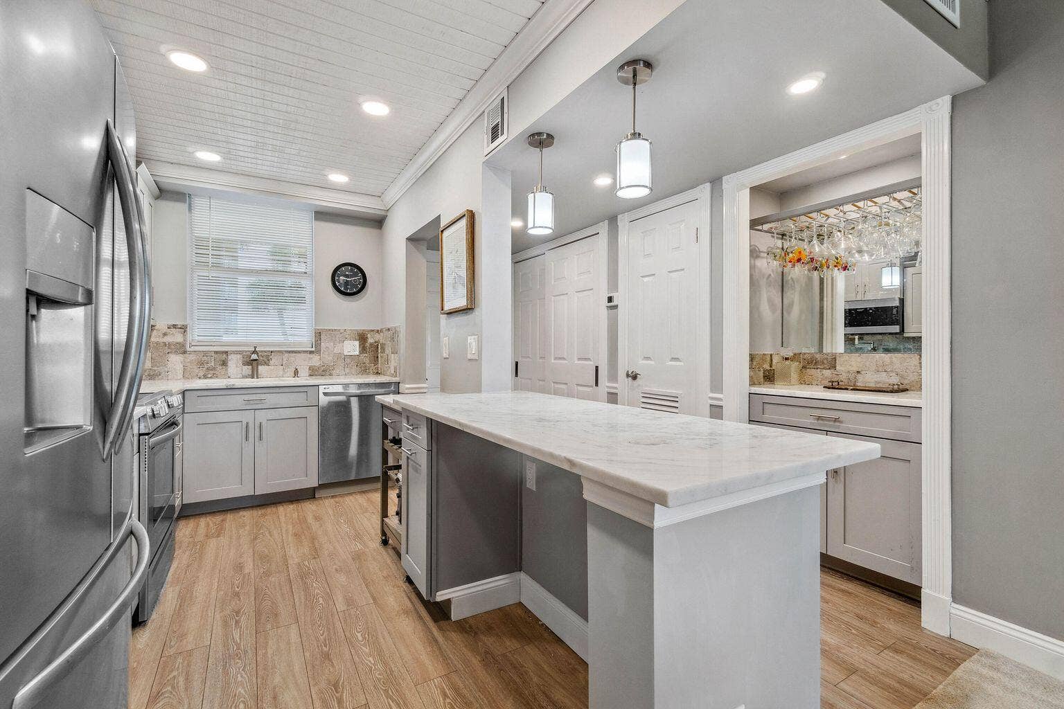 100 Paradise Harbour Boulevard, #208, North Palm Beach, FL 33408 Updated and open kitchen boasts shaker style cabinets, quartz countertops and stainless steel appliances