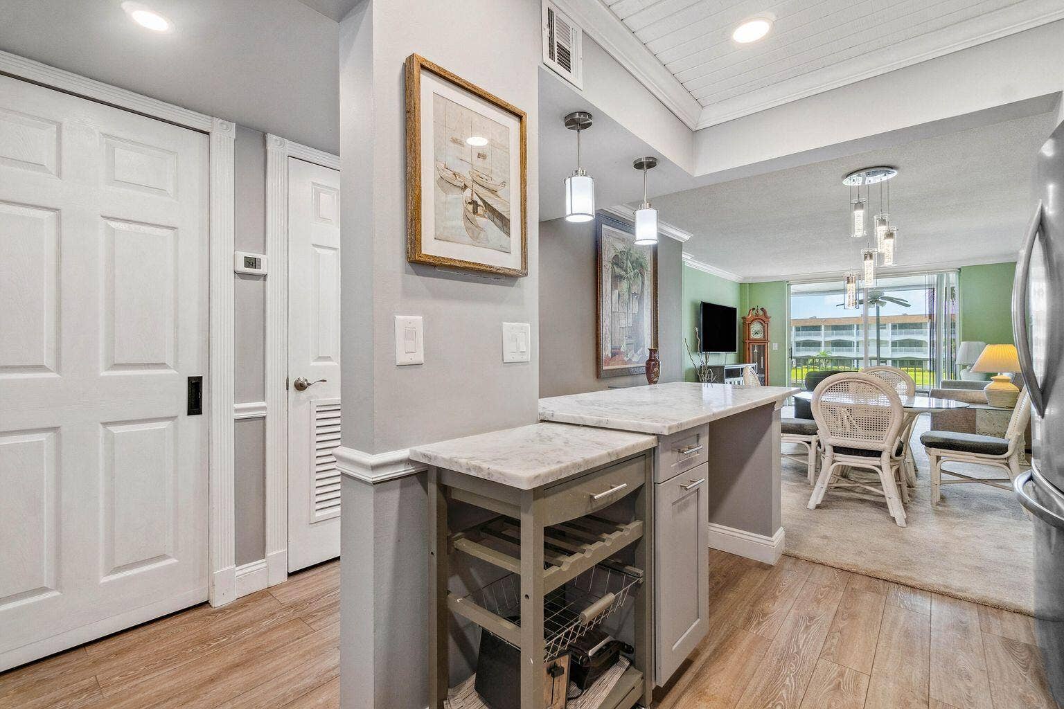 100 Paradise Harbour Boulevard, #208, North Palm Beach, FL 33408 Updated and open kitchen boasts shaker style cabinets, quartz countertops and stainless steel appliances
