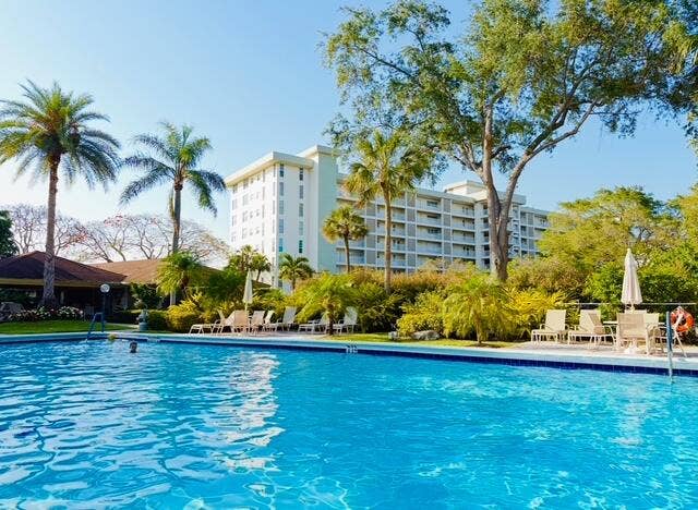3080 N Course Drive, #202, Pompano Beach, FL 33069 Poolside building impeccably maintained with new lounging furniture and propanebarbecues