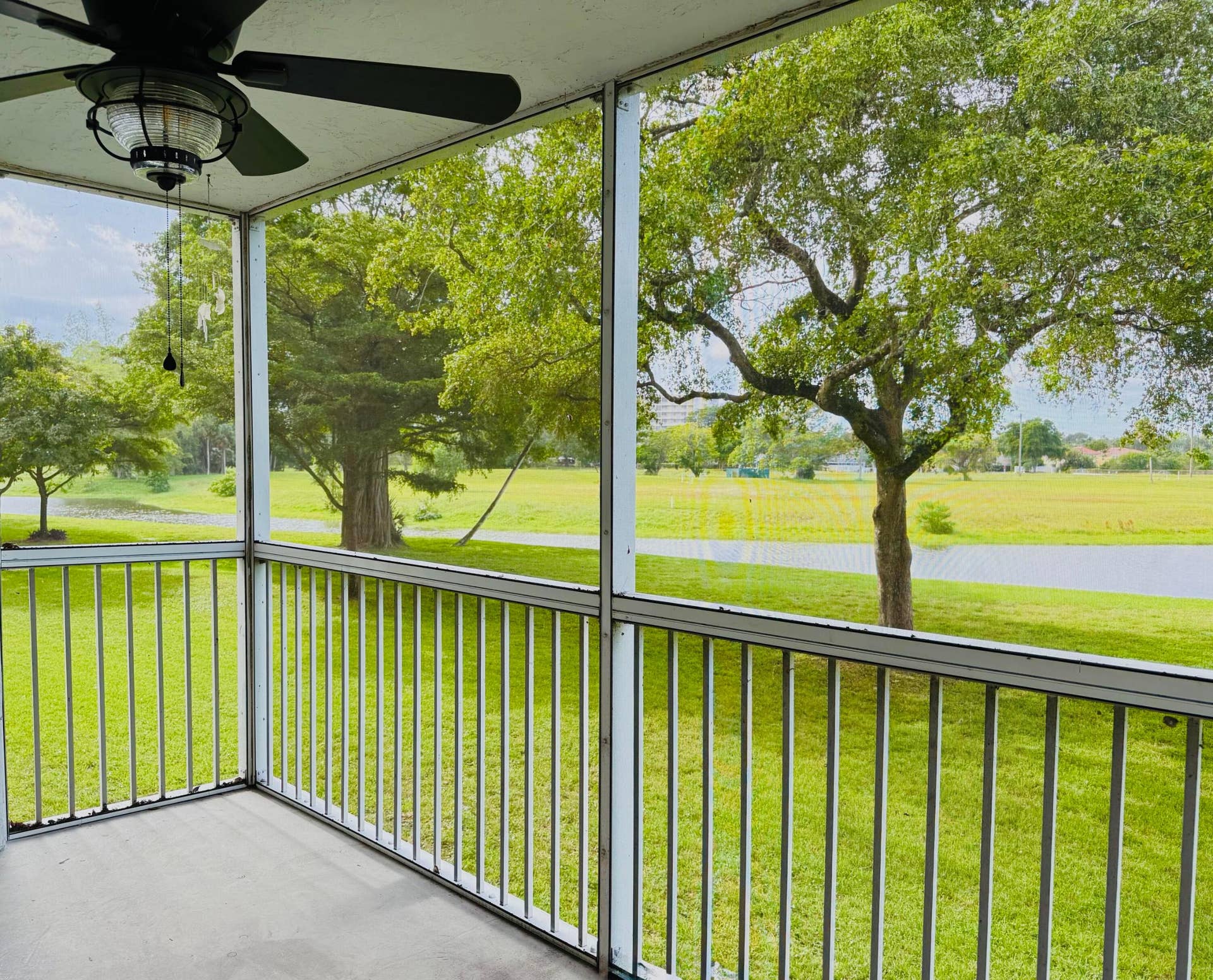 3080 N Course Drive, #202, Pompano Beach, FL 33069 screened in patio with wide lakeviews and west facing sunsets