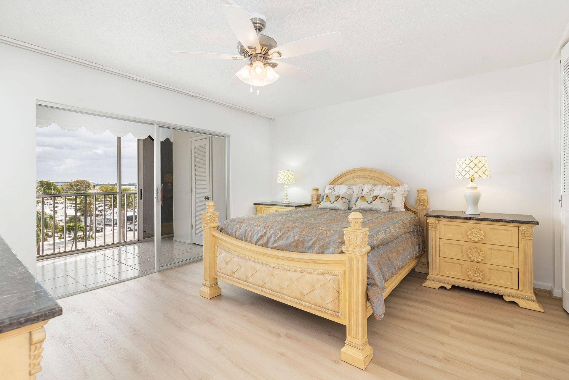 907 Marina Drive, #402, North Palm Beach, FL 33408 primary bedroom with new flooring & views of marina & intra coastal