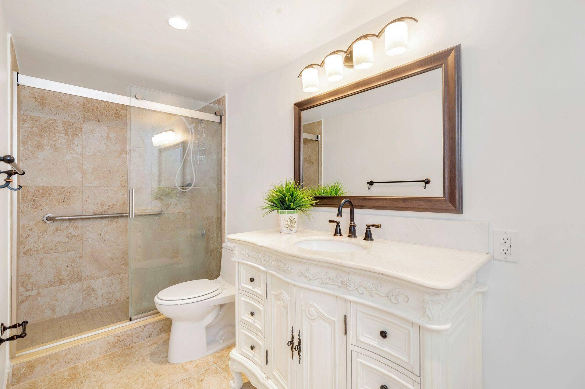 907 Marina Drive, #402, North Palm Beach, FL 33408 primary bathroom, frameless shower doors