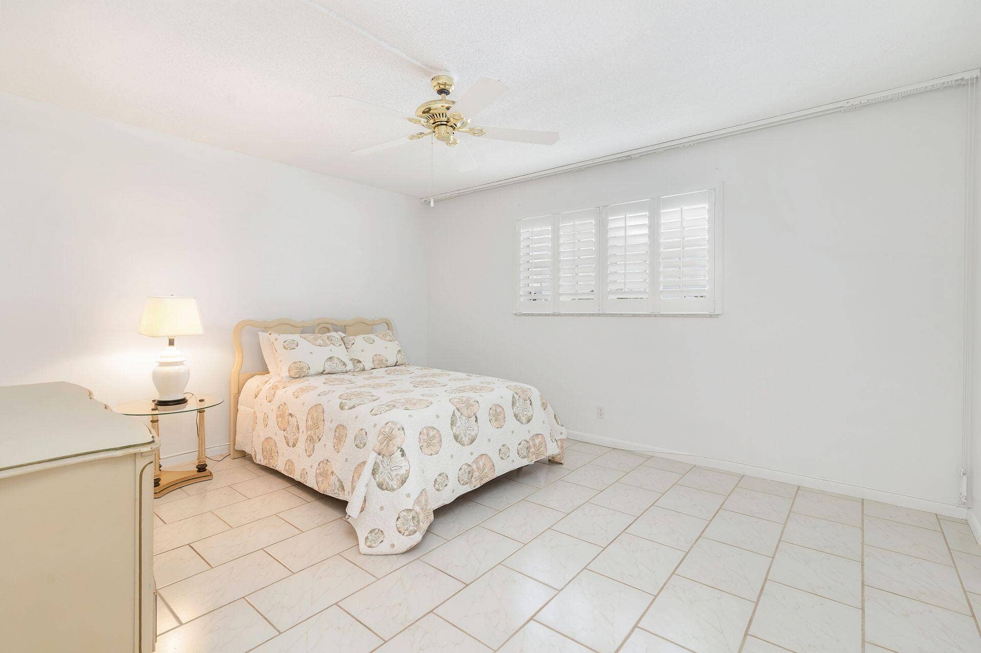907 Marina Drive, #402, North Palm Beach, FL 33408 guest bedroom with impact windows, plantation shutters