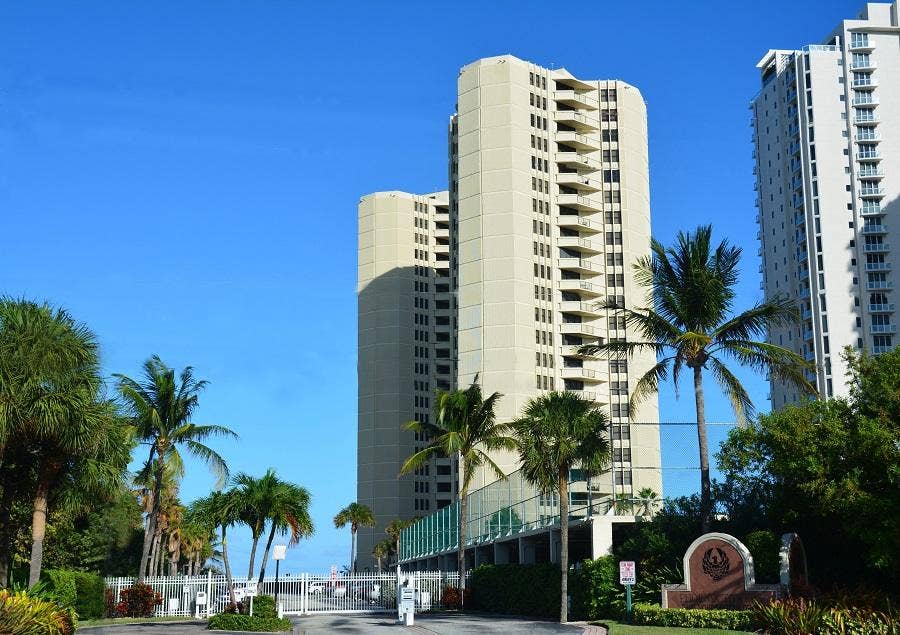Towering multi-story residential building with multiple private balconies