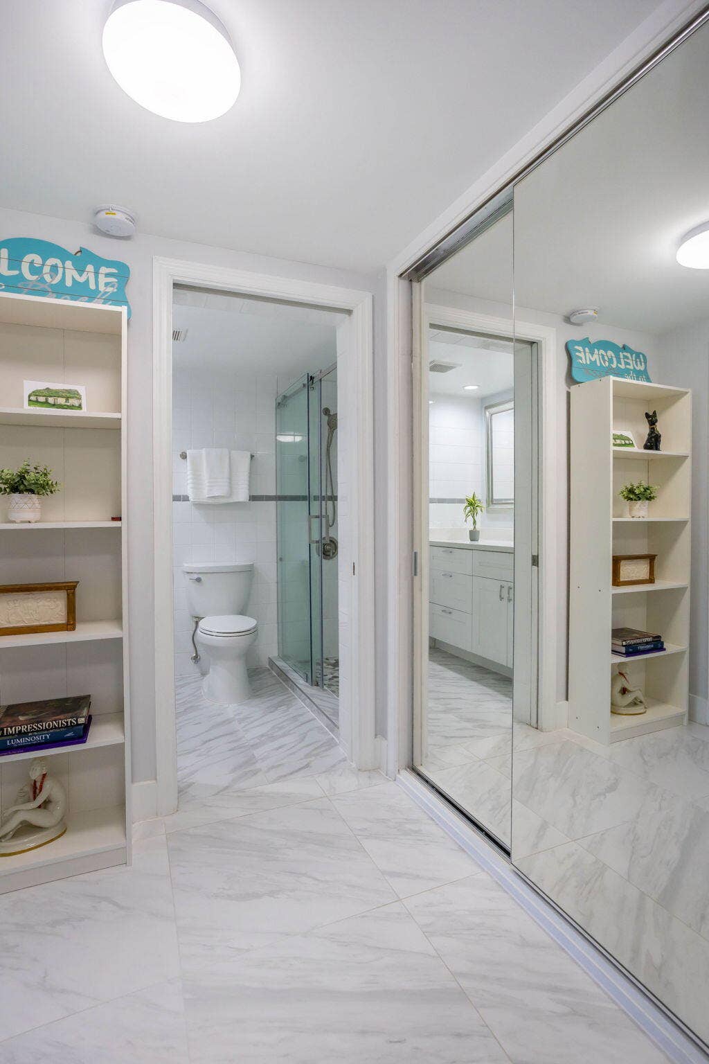Primary bedroom hallway with large custom closet and mirrored doors