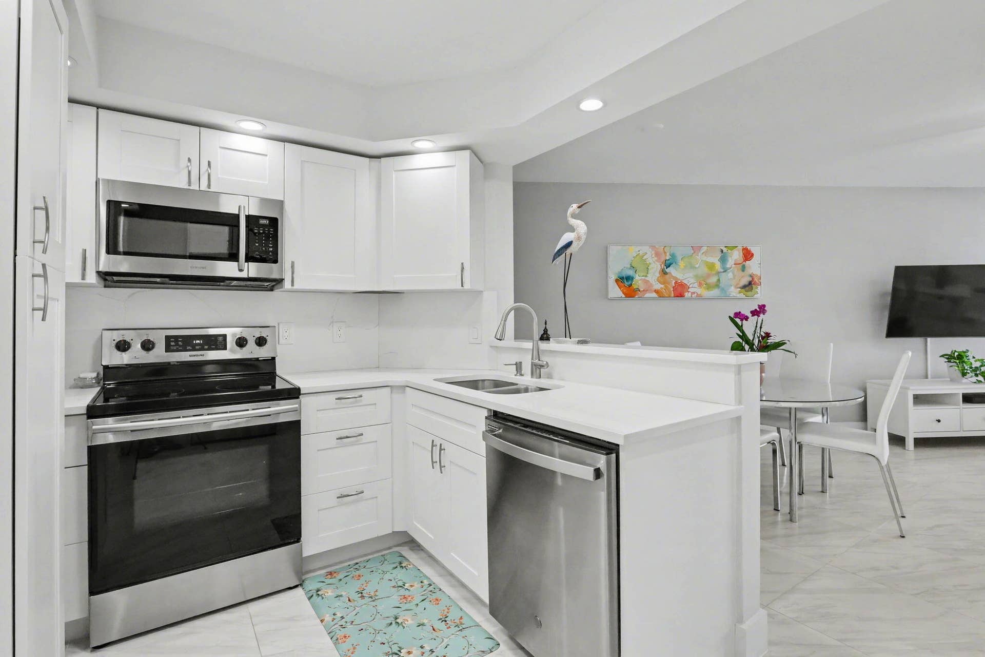 Beautiful bright, open kitchen concept with stainless-steel appliances and plenty of storage.