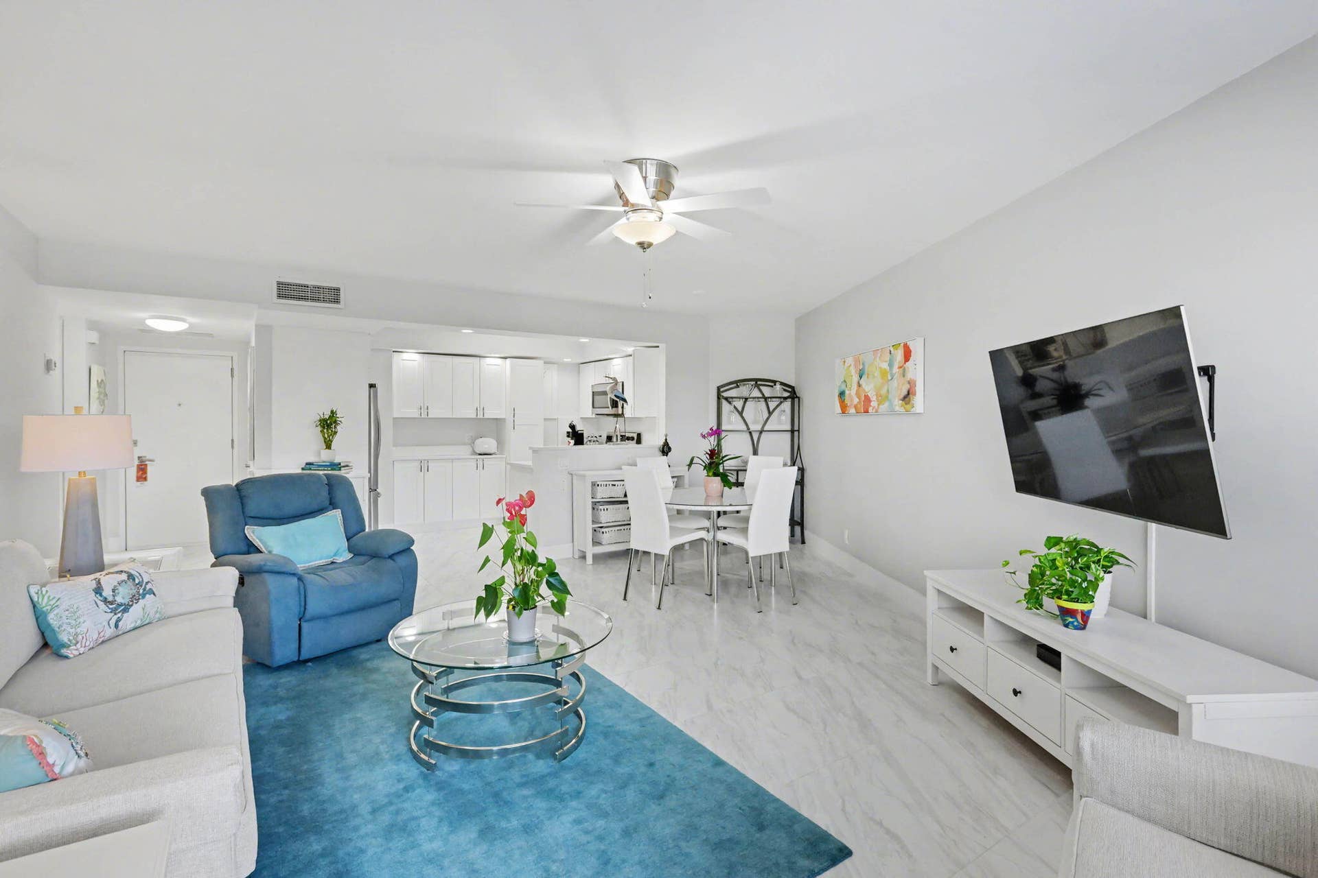 Living room facing kitchen and foyer