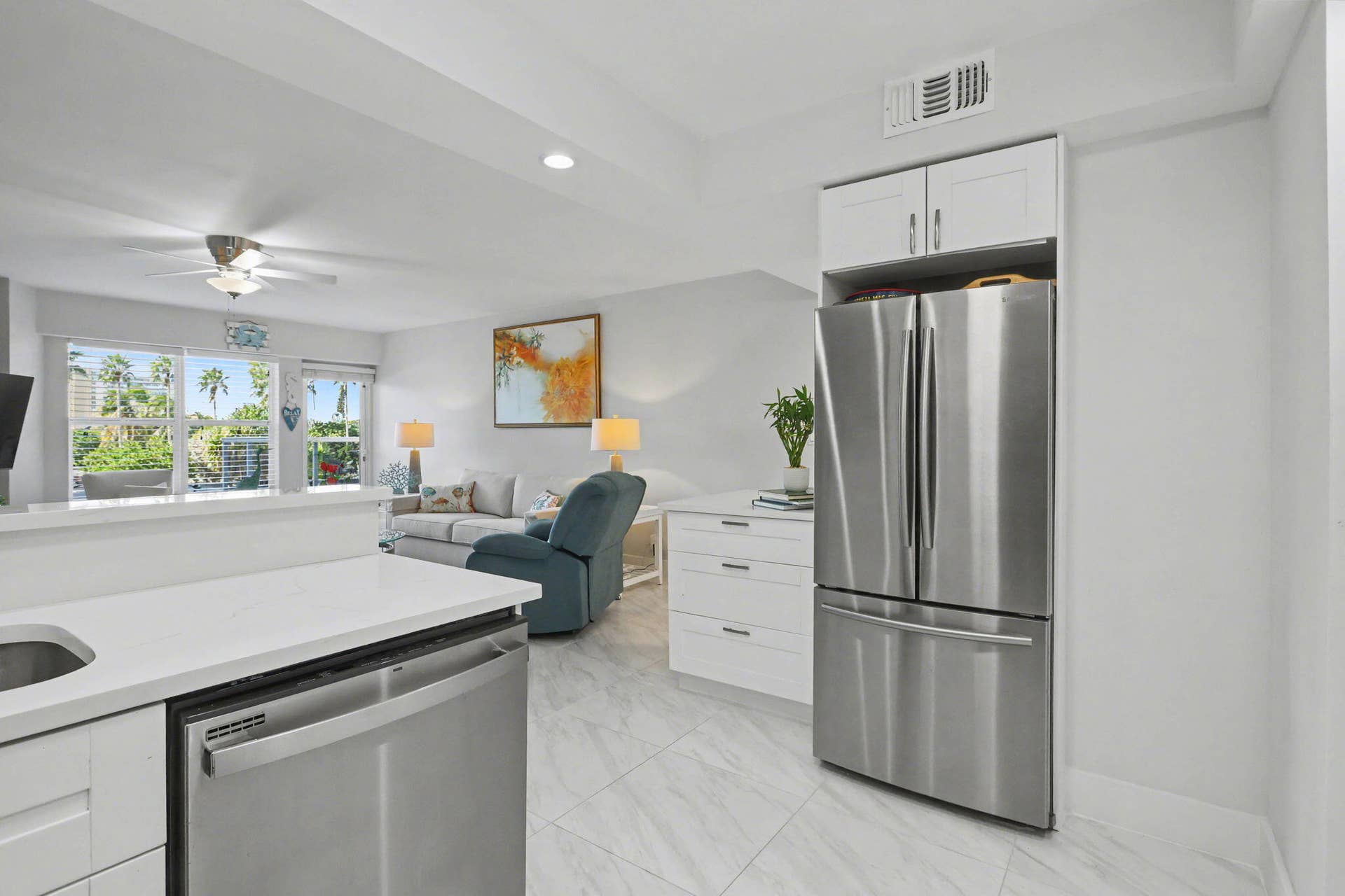 Beautiful fully renovated white and bright open kitchen concept with stainless steel appliances