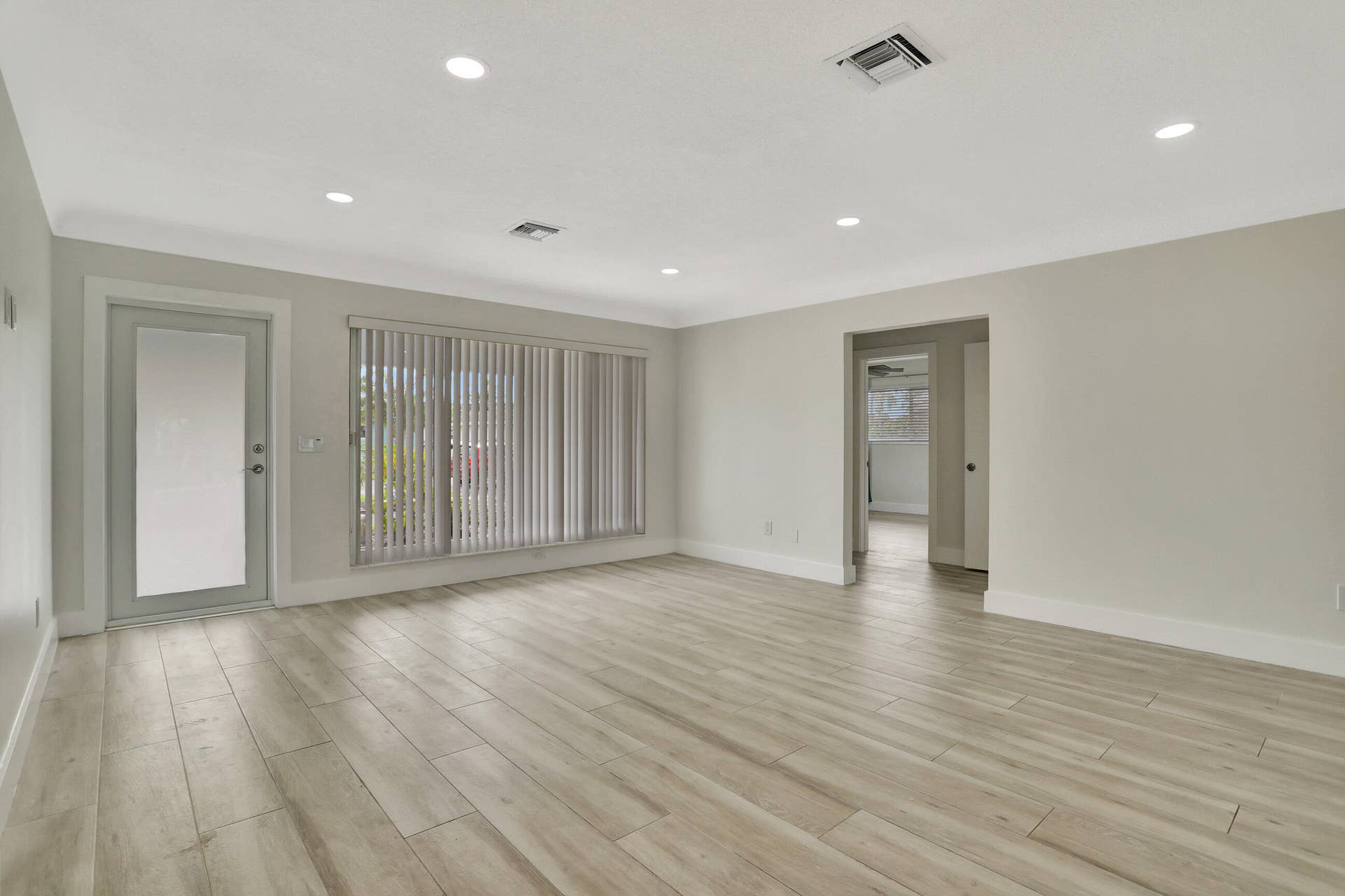 421 SE 5 Terrace, Pompano Beach, FL 33060 Facing the front door and large picture windows. Door on the right leads to the bedrooms.