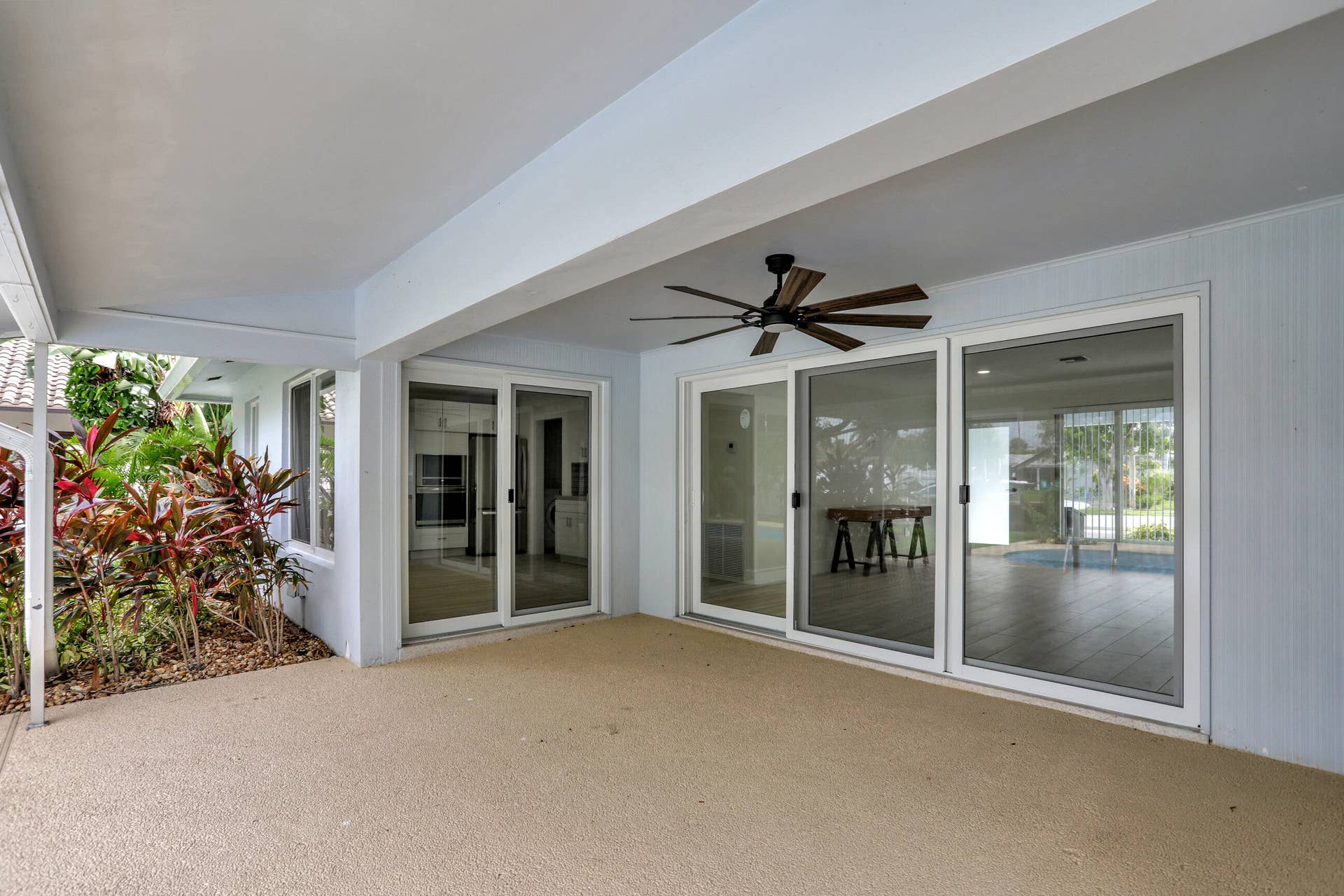 421 SE 5 Terrace, Pompano Beach, FL 33060 Nice large covered patio with ceiling fan. Updated wall with vertical design.