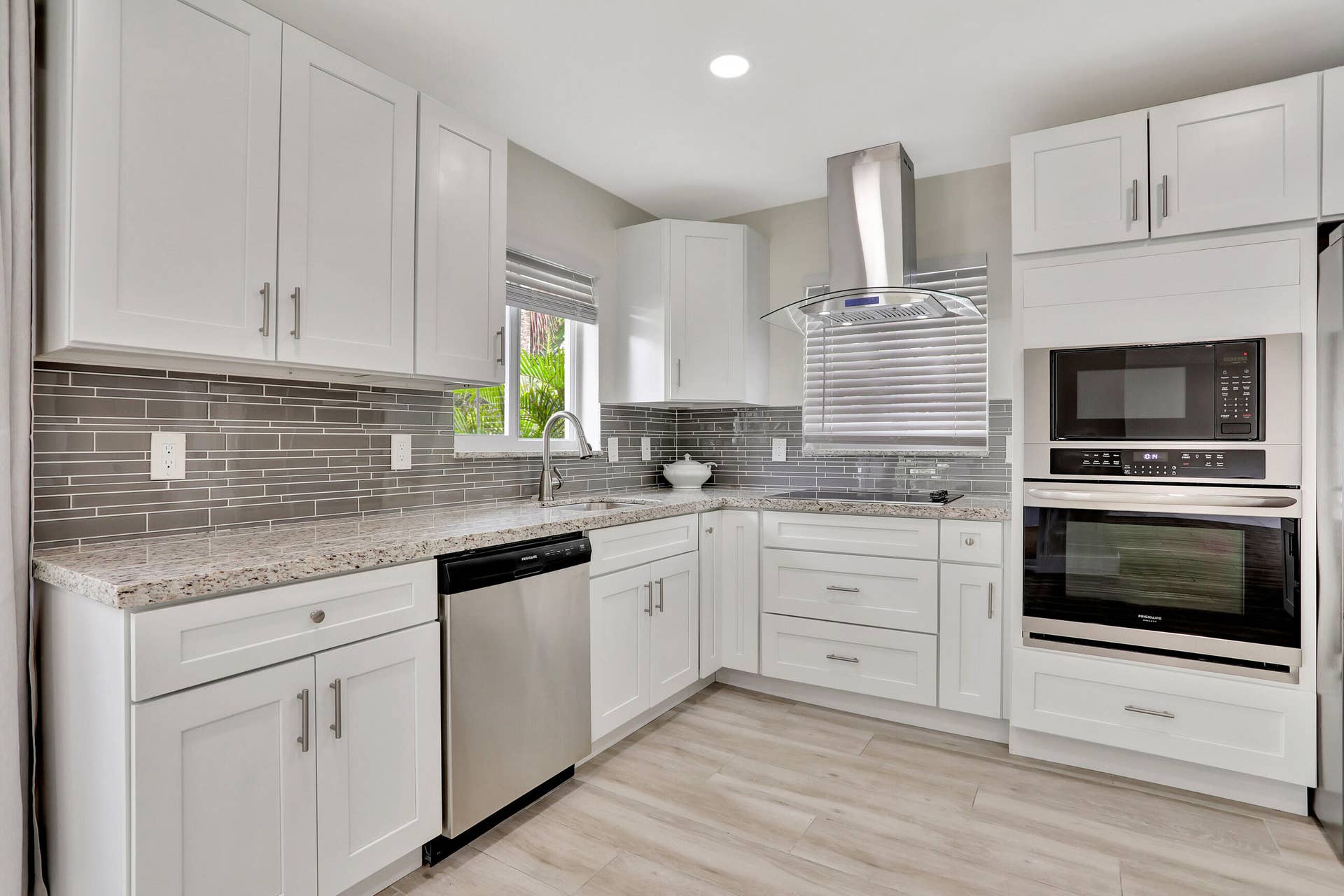 421 SE 5 Terrace, Pompano Beach, FL 33060 Kitchen with windows showing a serene landscape and water views. Kitchen has another side not shown in this photo.