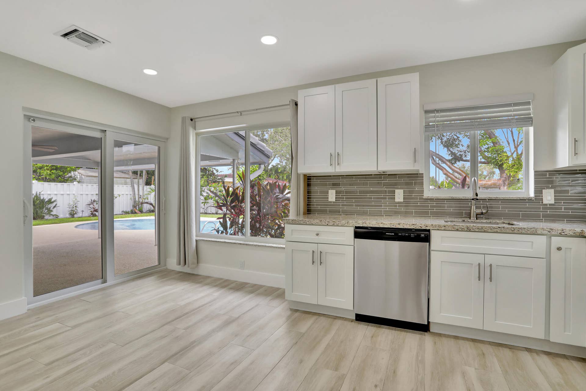 421 SE 5 Terrace, Pompano Beach, FL 33060 Dining area near kitchen has picture window water views with storm windows and sliders leading to the covered patio, pool and deck.