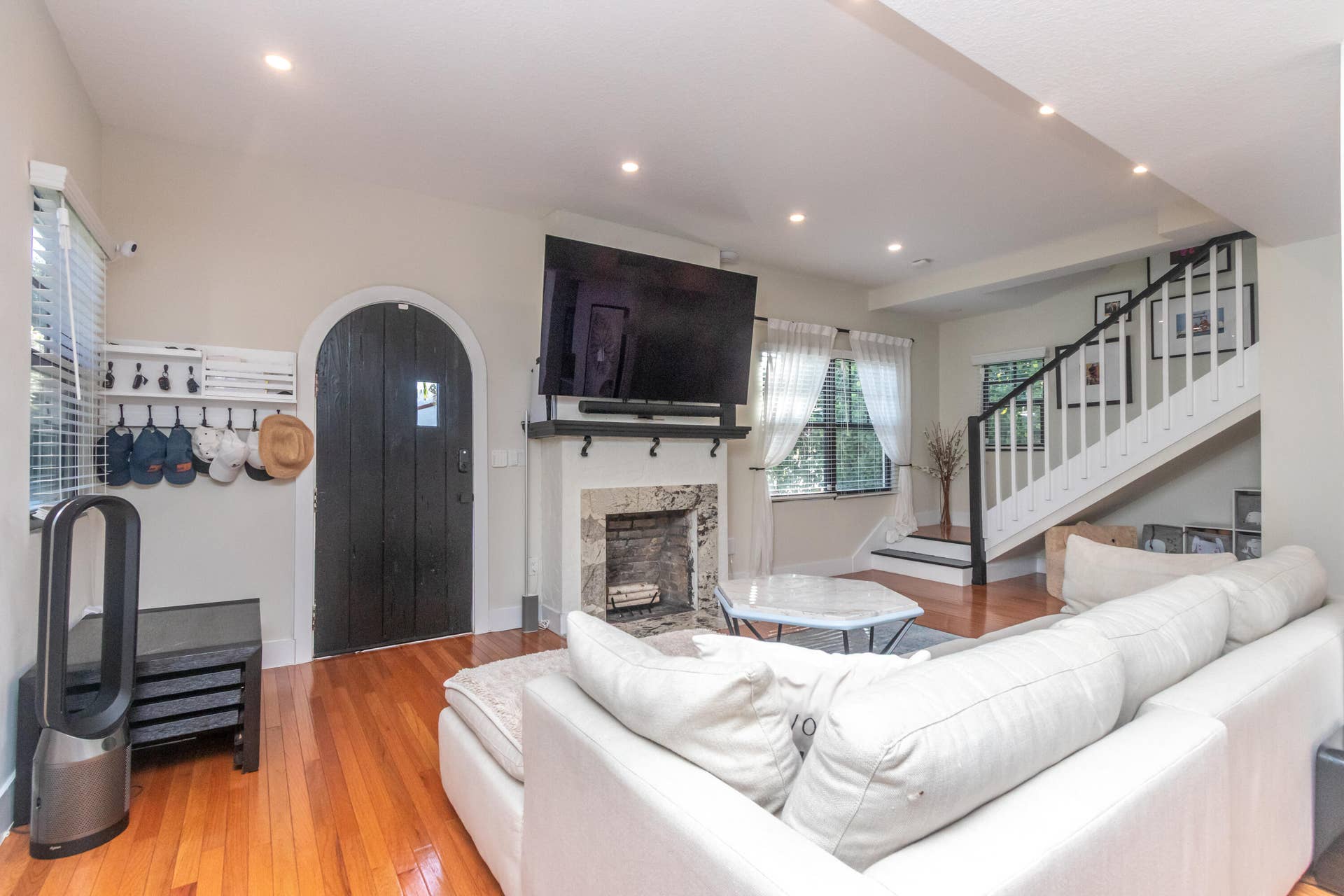 Spacious living room with cozy, wood burning fireplace