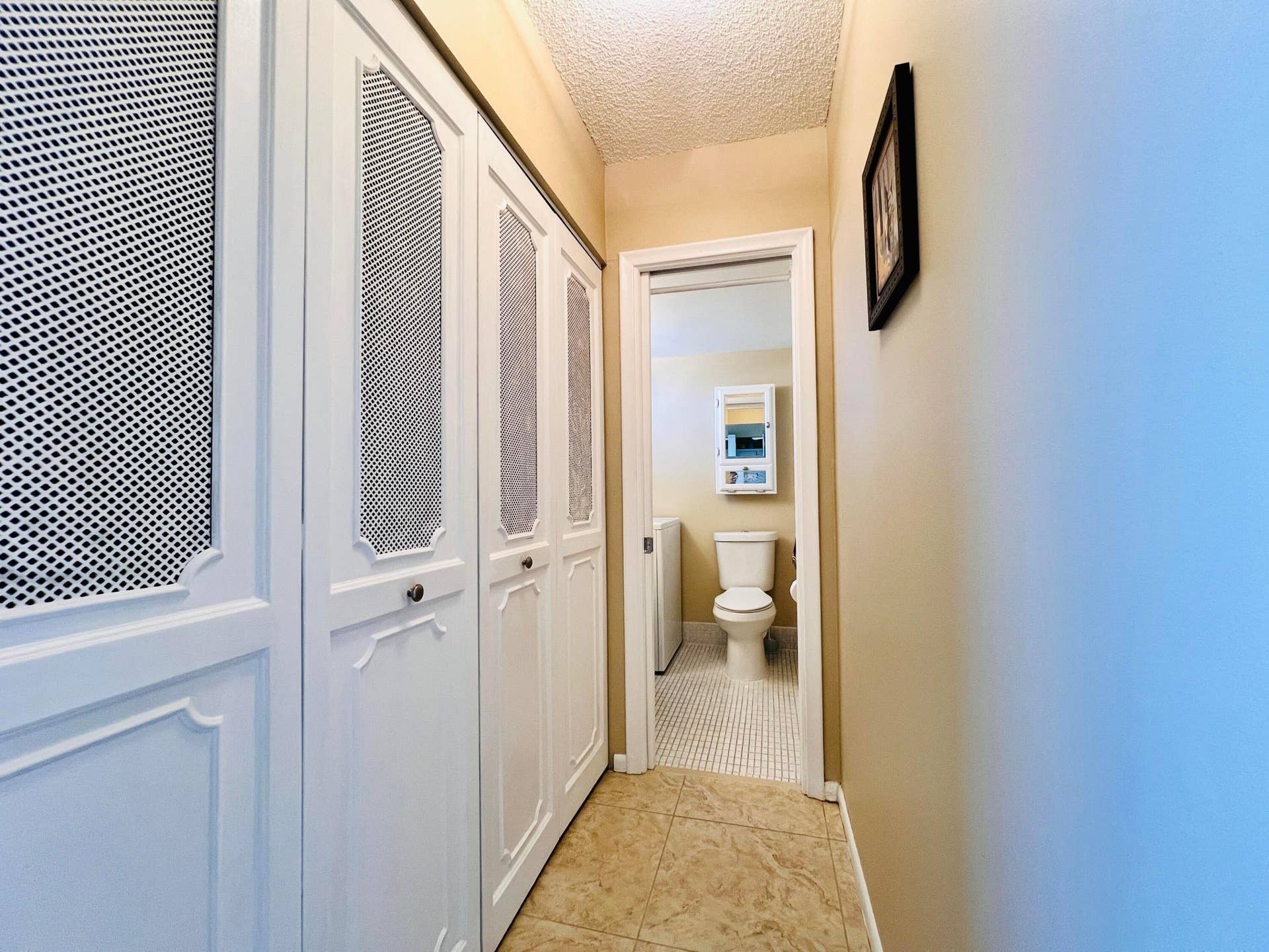 203 Oxford 500, West Palm Beach, FL 33417 Hall to Guest Bath Features A Wall of Closets for Extra Storage